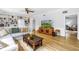Comfortable living area features custom shelving, wood flooring, and a traditional-style entertainment center at 1628 Long Bow Ln, Clearwater, FL 33764