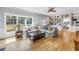 Spacious living room with a large window, comfortable seating, and custom built-in bookshelves at 1628 Long Bow Ln, Clearwater, FL 33764