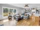 Bright living room features large windows, cozy seating, and stylish built-in shelving at 1628 Long Bow Ln, Clearwater, FL 33764
