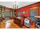 Well-appointed home office with custom built-ins, herringbone floors and a large executive desk at 1628 Long Bow Ln, Clearwater, FL 33764