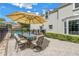 Inviting patio with dining set, perfect for outdoor meals and entertaining, next to pool and tennis court at 1628 Long Bow Ln, Clearwater, FL 33764