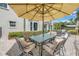 Outdoor patio area with ample seating under a large umbrella, ideal for entertaining at 1628 Long Bow Ln, Clearwater, FL 33764