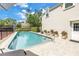Inviting pool with brick paver surround, landscaping, and privacy fence offers a relaxing outdoor space at 1628 Long Bow Ln, Clearwater, FL 33764