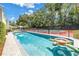 A refreshing pool alongside a tennis court provides a delightful outdoor recreation area at 1628 Long Bow Ln, Clearwater, FL 33764