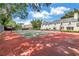 Well-maintained tennis court with view of pool and beautiful home, perfect for recreation and relaxation at 1628 Long Bow Ln, Clearwater, FL 33764