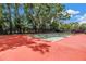 Private tennis court providing recreation and exercise in a secure, fenced-in outdoor setting at 1628 Long Bow Ln, Clearwater, FL 33764