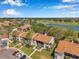 Scenic aerial view of condo community overlooking golf course and lake under a blue sky at 2049 Skimmer W Ct # 311, Clearwater, FL 33762
