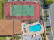 Aerial view of the community pool, tennis court, and parking area at 2049 Skimmer W Ct # 311, Clearwater, FL 33762