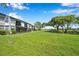 The condo backyard featuring lush green space with mature trees extending to the golf course at 2049 Skimmer W Ct # 311, Clearwater, FL 33762
