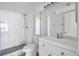All-white bathroom featuring a shower, toilet, modern sink, and a large mirror at 2049 Skimmer W Ct # 311, Clearwater, FL 33762