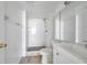 Bathroom featuring a shower, toilet, modern sink, large mirror, and a towel rack at 2049 Skimmer W Ct # 311, Clearwater, FL 33762