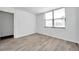Bright bedroom with a large window and modern gray wood flooring at 2049 Skimmer W Ct # 311, Clearwater, FL 33762