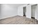 Bedroom featuring gray wood floors and easy access to the bathroom and closet at 2049 Skimmer W Ct # 311, Clearwater, FL 33762