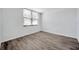 Bedroom featuring a large window providing natural light with gray wood flooring at 2049 Skimmer W Ct # 311, Clearwater, FL 33762