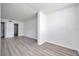 A bedroom features modern gray wood flooring, white walls, and a bathroom entrance at 2049 Skimmer W Ct # 311, Clearwater, FL 33762