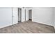 Bedroom featuring gray wood floors, fresh paint and easy access to the bathroom at 2049 Skimmer W Ct # 311, Clearwater, FL 33762