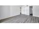 A bedroom features modern gray wood flooring, white walls, closet and bathroom entrances at 2049 Skimmer W Ct # 311, Clearwater, FL 33762