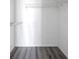 A white closet with shelf space and gray wood flooring at 2049 Skimmer W Ct # 311, Clearwater, FL 33762