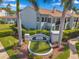 View of a condominium complex with mature palm trees and landscaping features at 2049 Skimmer W Ct # 311, Clearwater, FL 33762