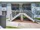Exterior view of the condo featuring a private screened lanai accessible by stairs at 2049 Skimmer W Ct # 311, Clearwater, FL 33762