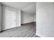 Hallway displaying the gray wood flooring and freshly painted white walls at 2049 Skimmer W Ct # 311, Clearwater, FL 33762