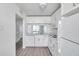 The recently remodeled kitchen features all white appliances, cabinets and countertops at 2049 Skimmer W Ct # 311, Clearwater, FL 33762