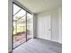 Enclosed lanai featuring gray floors and a view of the backyard at 2049 Skimmer W Ct # 311, Clearwater, FL 33762