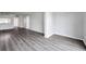 Spacious living room featuring stylish gray wood flooring throughout the living space at 2049 Skimmer W Ct # 311, Clearwater, FL 33762