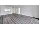 Spacious living room featuring durable gray flooring with views into the kitchen at 2049 Skimmer W Ct # 311, Clearwater, FL 33762
