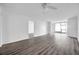 Open-concept living room with sliding glass doors and contemporary gray wood flooring at 2049 Skimmer W Ct # 311, Clearwater, FL 33762