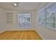Bedroom with hardwood floors, ceiling fan, built-in shelving and windows at 2201 Bay Club Cir, Tampa, FL 33607
