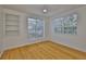 Bedroom with hardwood floors, ceiling fan, built-in shelving and windows at 2201 Bay Club Cir, Tampa, FL 33607
