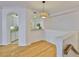 Dining area view showcasing hardwood floors, open kitchen, and overhead lighting fixture at 2201 Bay Club Cir, Tampa, FL 33607