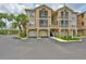 Beautiful building exterior featuring multiple garages, screened patios, and professional landscaping at 2201 Bay Club Cir, Tampa, FL 33607