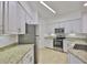 Well-equipped kitchen with stainless steel appliances, granite countertops, and ample white cabinetry at 2201 Bay Club Cir, Tampa, FL 33607