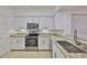 Bright kitchen featuring stainless steel appliances, granite countertops, and ample white cabinets for storage at 2201 Bay Club Cir, Tampa, FL 33607