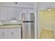 Kitchen with stainless steel refrigerator, granite counters and access to laundry room at 2201 Bay Club Cir, Tampa, FL 33607