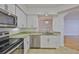 Bright kitchen featuring stainless steel appliances, granite counters and white cabinets at 2201 Bay Club Cir, Tampa, FL 33607