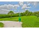 Community pet area featuring lush grass and convenient waste disposal station for residents and their companions at 2201 Bay Club Cir, Tampa, FL 33607