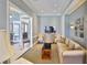Cozy sitting room featuring comfortable sofa, accent chairs, modern lighting, and a sleek TV at 2201 Bay Club Cir, Tampa, FL 33607