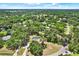 An aerial view of a home nestled amongst mature trees with a screened-in pool area and lush green surroundings at 2515 Pemberton Creek Dr, Seffner, FL 33584