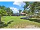 Expansive backyard featuring a screened pool area, a trampoline, and a spacious grassy lawn at 2515 Pemberton Creek Dr, Seffner, FL 33584
