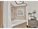 Well-lit bathroom featuring a tub with shower, a window, and a modern vanity with drawers and storage at 2515 Pemberton Creek Dr, Seffner, FL 33584