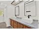 Bright bathroom featuring dual sinks, granite countertops and wood cabinetry at 2515 Pemberton Creek Dr, Seffner, FL 33584