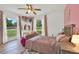 Charming bedroom with hardwood floors, soft pink accents, and ample natural light from large windows at 2515 Pemberton Creek Dr, Seffner, FL 33584