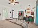 Comfortable bedroom featuring hardwood floors, a ceiling fan, a desk and well-organized closet space at 2515 Pemberton Creek Dr, Seffner, FL 33584