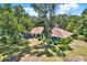 Aerial view of a single-story home with mature trees, a well-manicured lawn, and beautiful landscaping at 2515 Pemberton Creek Dr, Seffner, FL 33584