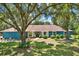 Charming single-story home with blue siding and mature landscaping under the shade of large trees at 2515 Pemberton Creek Dr, Seffner, FL 33584