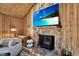 Close-up of the stone fireplace with a decorative screen and mounted television in a cozy living room at 2515 Pemberton Creek Dr, Seffner, FL 33584