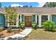 Inviting front entrance with double doors, surrounded by lush greenery and decorative plants at 2515 Pemberton Creek Dr, Seffner, FL 33584